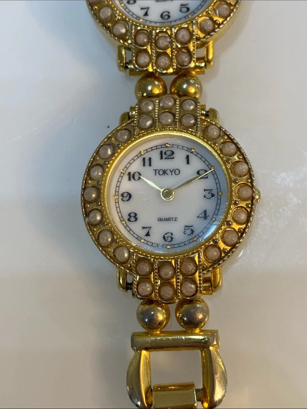 Faux pearl gold tone watch